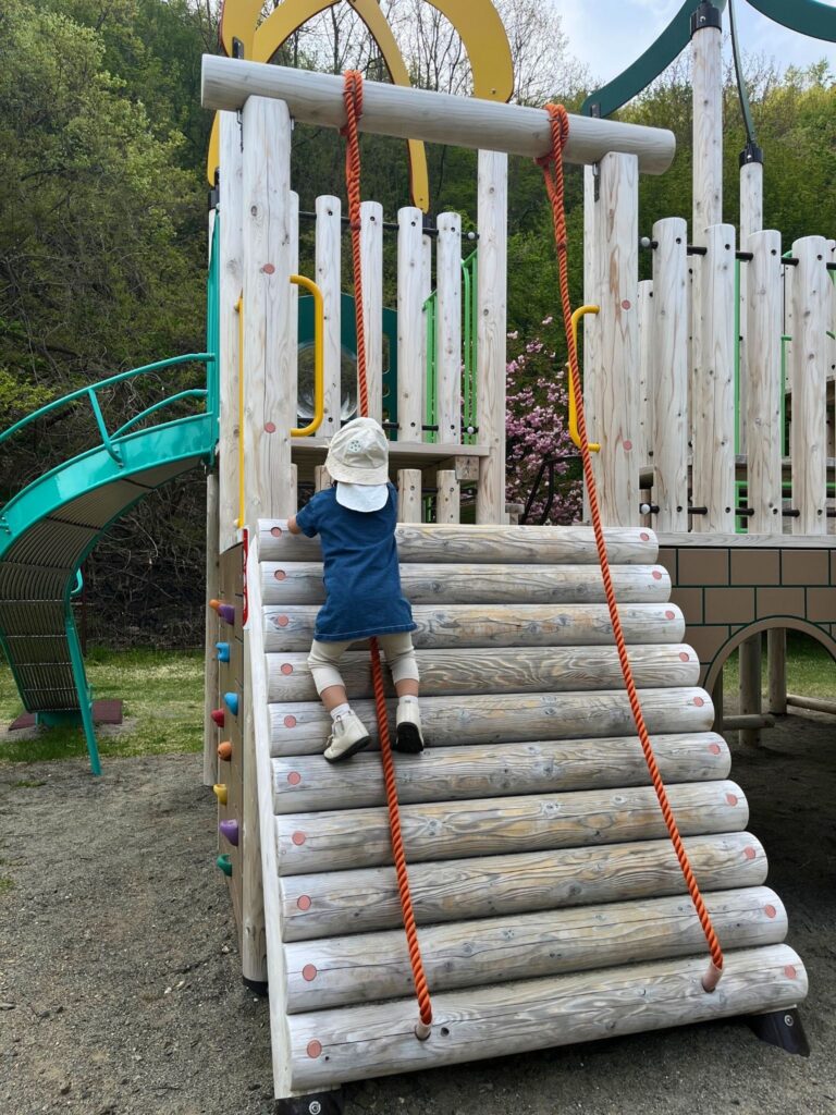 地附山公園の大型複合遊具-ロープ登りをする子ども